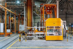 Detailed view of machinery in an operational glass factory in Dar es Salaam.
